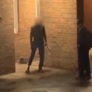 A man was recorded allegedly holding a knife outside a flat in Nine Elms